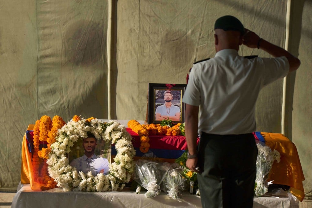 A member of the Nepalese army pays his respects to Bipin Joshi, a Nepali man who was taken hostage by Hamas, during a memorial procession at the Kathmandu airport in Nepal. Photo: AP