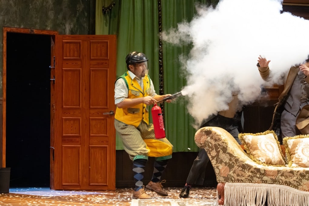 Michael Mok lets off a fire extinguisher in a scene from The Play That Goes Wrong, a Cantonese adaptation of the West End and Broadway hit that won best new comedy at the 2015 Laurence Olivier Awards, at the Kwai Tsing Theatre in Hong Kong on October 18, 2025. Photo: Chung Ying Theatre