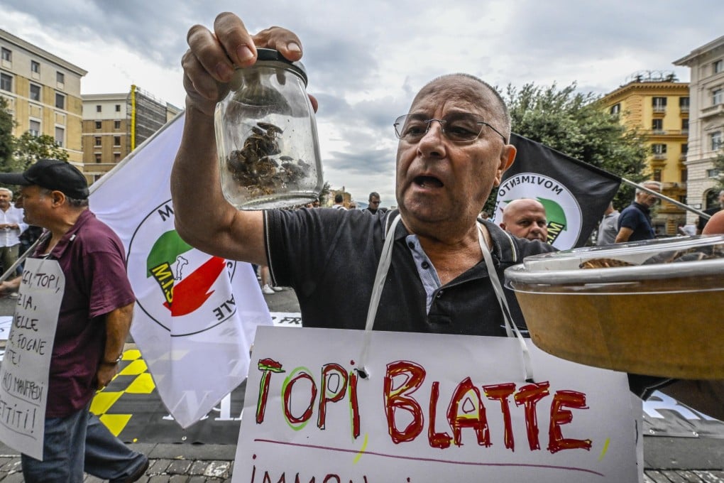 Raffaele Bruno, national secretary of the Movimento Idea Sociale, holds a jar containing live cockroaches during a protest in front of the City Hall in Naples, southern Italy, on September 24. Photo: EPA