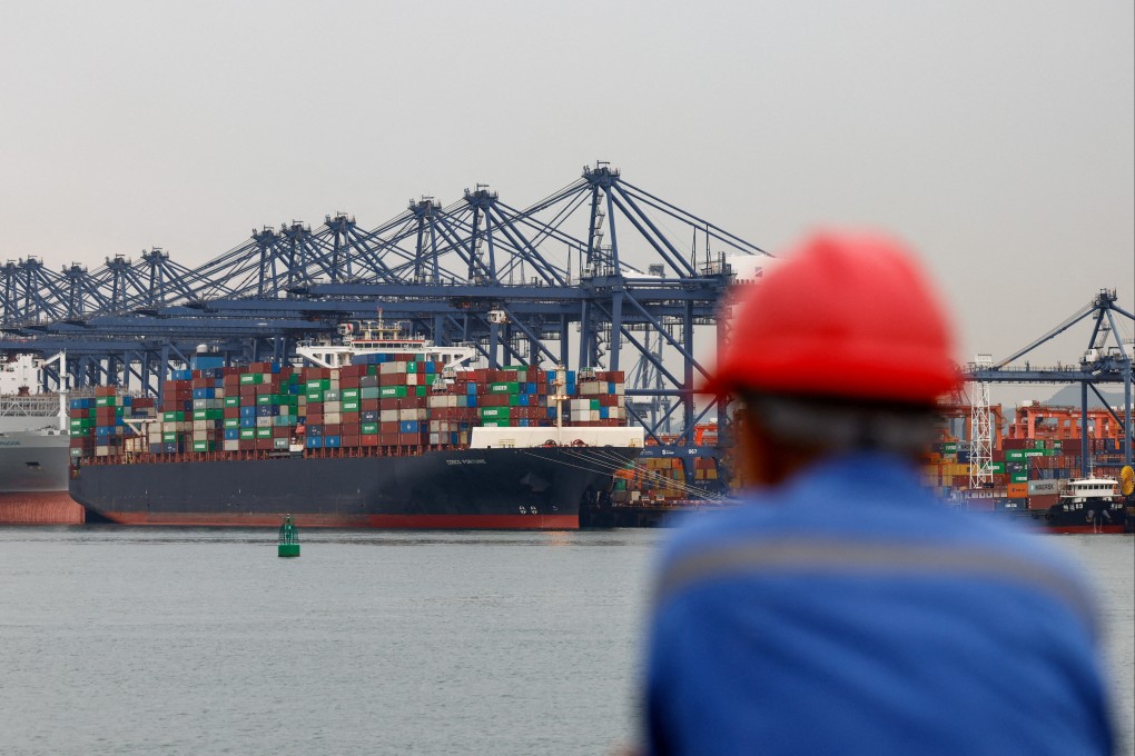 A worker looks on near a cargo ship carrying containers at the Yantian port in Shenzhen, Guangdong province on May 9, 2025. Photo: Reuters