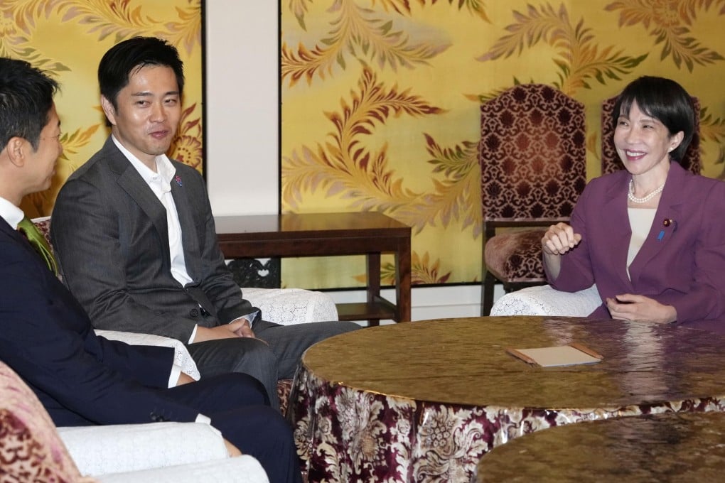 Sanae Takaichi (right), the leader of the Liberal Democratic Party, meets Hirofumi Yoshimura (second left) and Fujmitake Fuijta, leaders of the Japan Innovation Party in parliament in Tokyo, on Wednesday. Photo: Kyodo News via AP