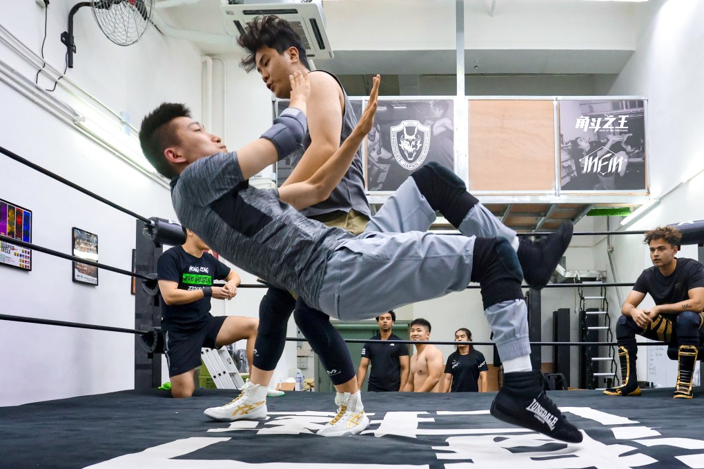 Wrestlers practise a move at a Hong Kong Wrestling Federation Pro Wrestling training session. A leader of the group talks about an upcoming event and why he wants people “to enjoy the experience”. Photo: Jonathan Wong