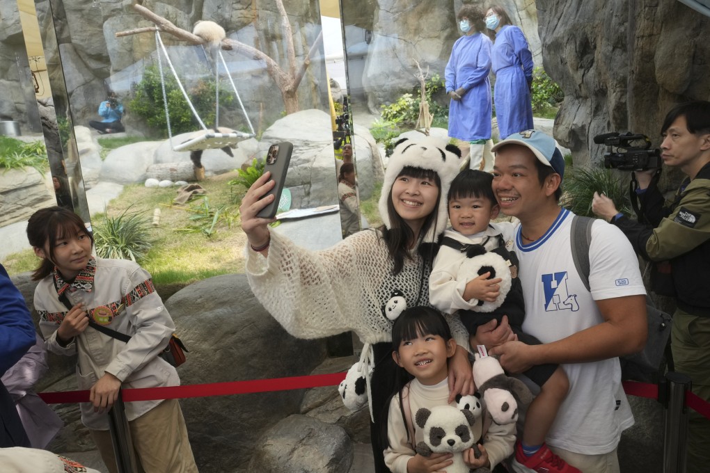 A family decked out in panda merchandise poses for a picture at Ocean Park. Photo: Sam Tsang