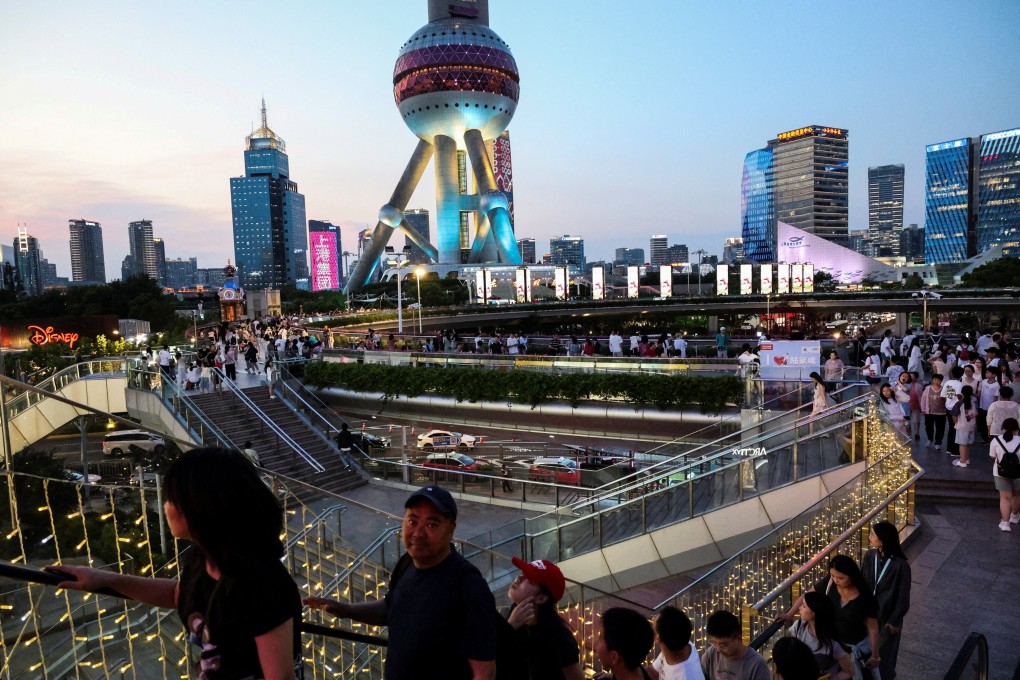 People walk on a pedestrian bridge in the Lujiazui financial district in Shanghai on July 14. Photo: Reuters