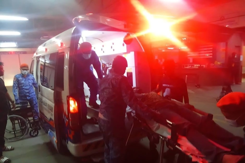 A person injured in the fireworks blast in Kulim, Malaysia, on Monday night is transported by ambulance. Photo: Facebook
