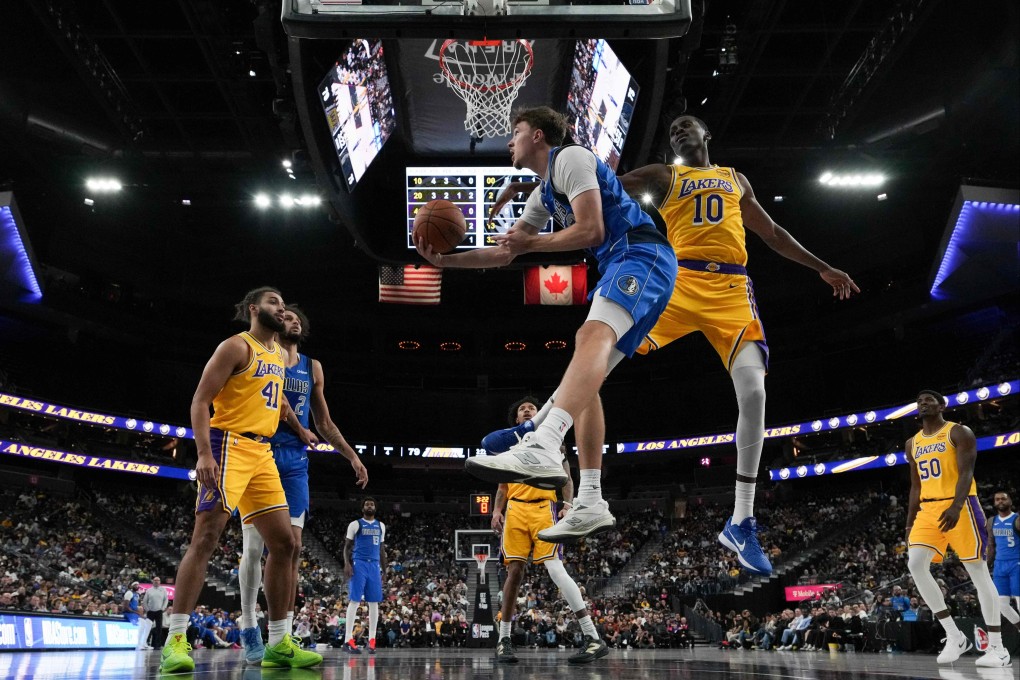 Dallas Mavericks rookie Cooper Flagg (centre) shoots against Christian Koloko of the Los Angeles Lakers in the second half of a pre-season game. Photo: Getty Images