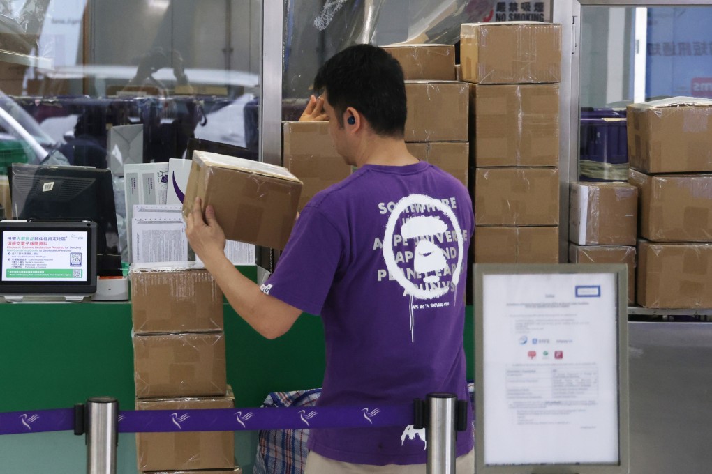 People mail parcels at the General Post Office in Central on April 16.  The US’ elimination of a duty-free policy for small parcels delivered through the postal channel has resulted in a drop in air mail volume. Photo: Jelly Tse