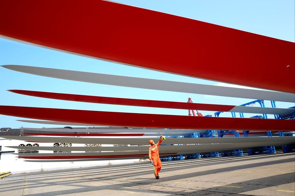 A worker inspects super-large wind turbine blades at a port in China’s eastern Jiangsu province. Photo: Getty Images