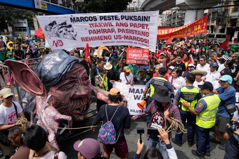 An effigy of Philippine President Ferdinand Marcos Jnr is pushed to the front of the crowd during a farmer-led anti-corruption rally on Tuesday near the Malacanang presidential palace in Manila, the Philippines. Photo: AP