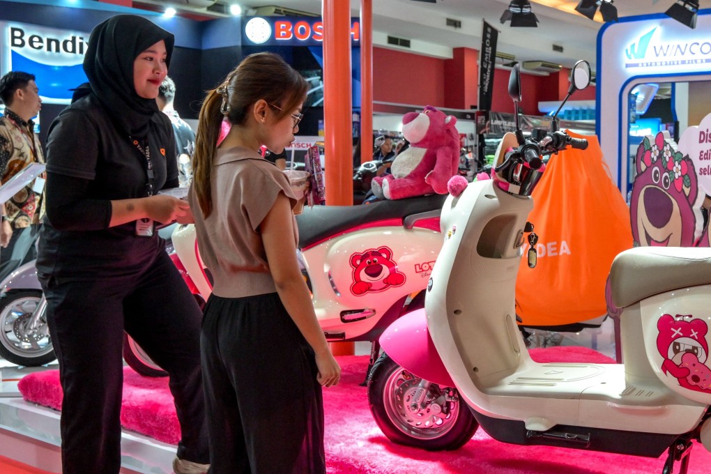 Visitors look at two-wheeled electric vehicles by Yadea at the Indonesia International Motor Show 2025 in Jakarta on November 14. Chinese companies like Yadea are starting to roll out alternative batteries like sodium-ion or salt batteries. Photo: AFP