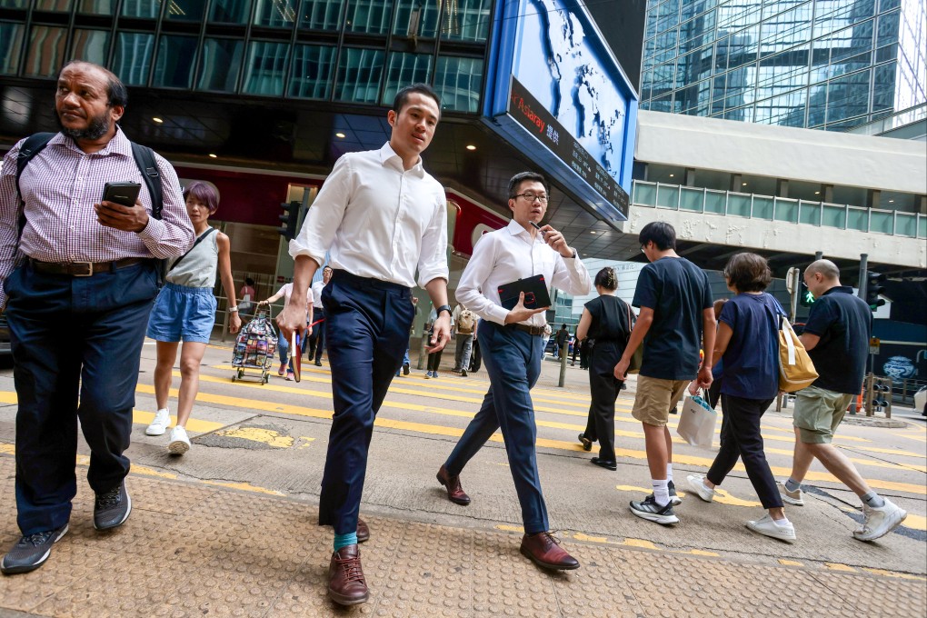 People cross a street in Central on October 20, 2025. Photo: Jonathan Wong