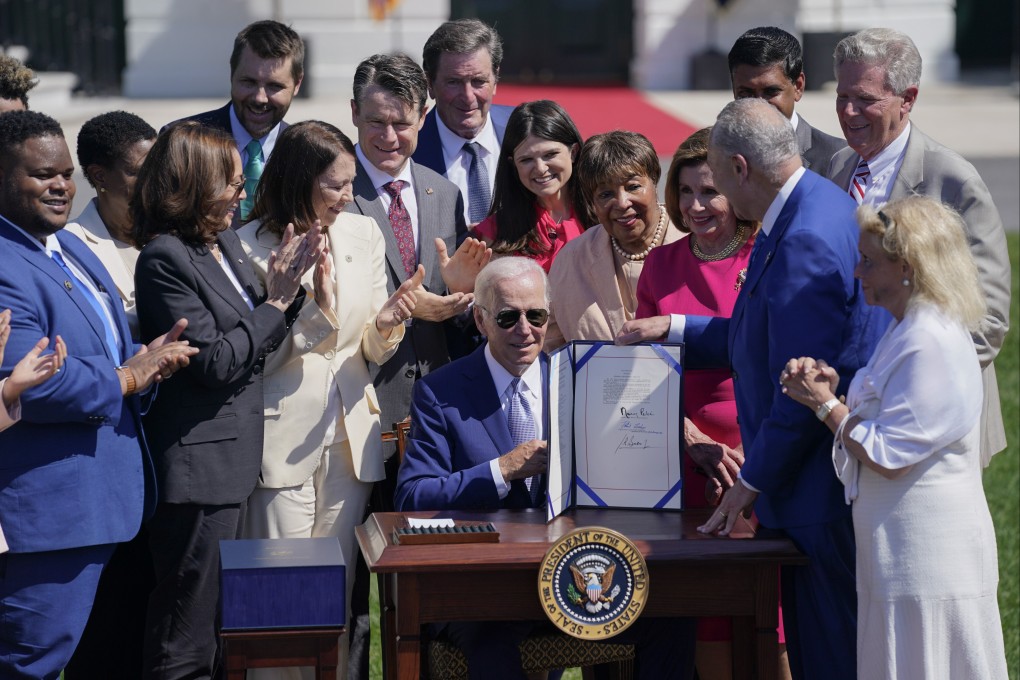 US President Joe Biden holds the “Chips and Science Act of 2022” after signing it during a ceremony on the South Lawn of the White House on August 9, 2022. Photo: AP