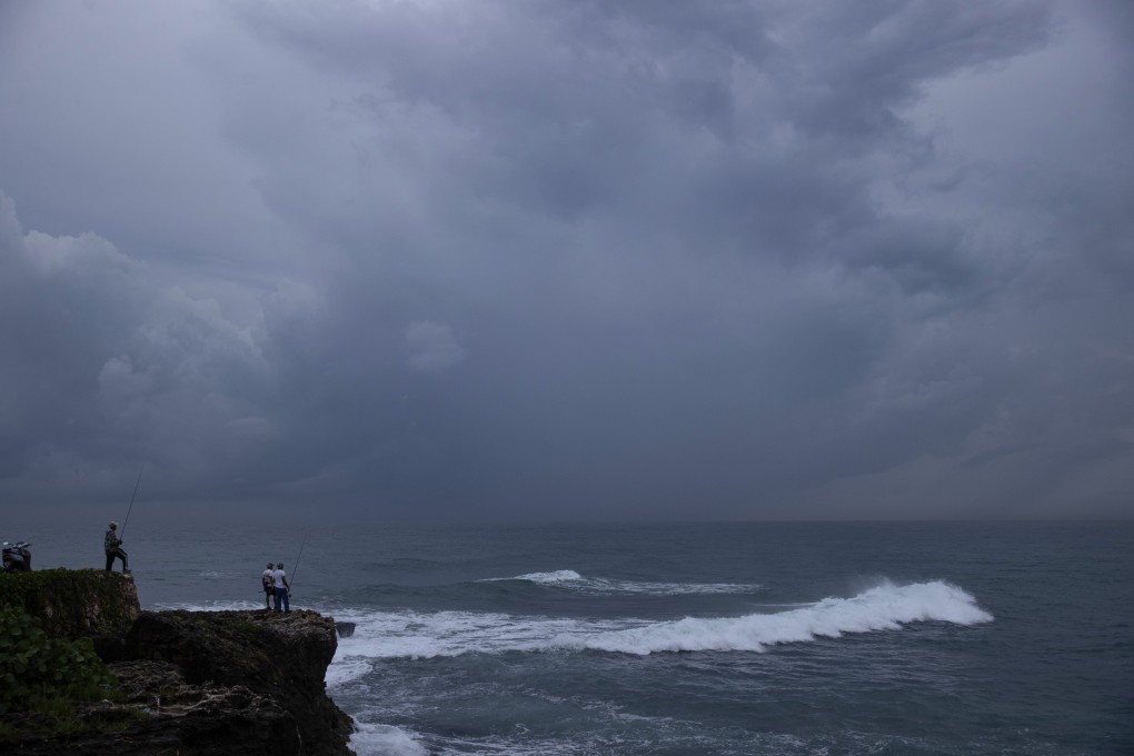 A man fishes on the waterfront in Santo Domingo on Wednesday as the Dominican Republic remains on alert for Tropical Storm Melissa. Photo: EPA