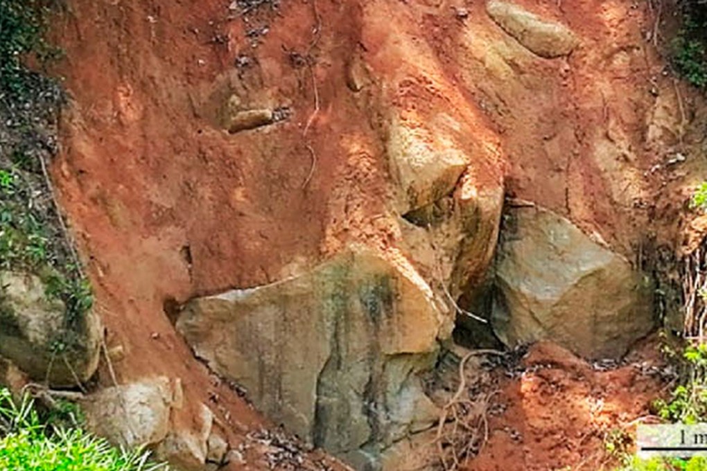 A geological section at the southern rim of the Jilin crater shows a mix of red granite weathered soil and granite fragments. Photo: Handout