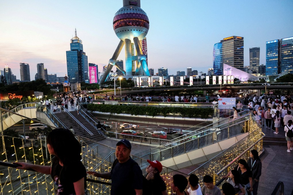 People walk on a pedestrian bridge at Lujiazui financial district in Shanghai on July 14. Photo: Reuters