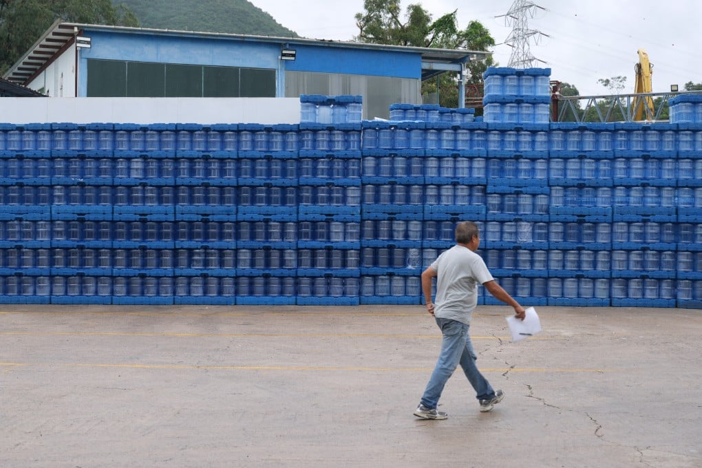 A person walks past empty distilled water bottles at a logistics company in Yuen Long, on August 19. Photo: Sam Tsang