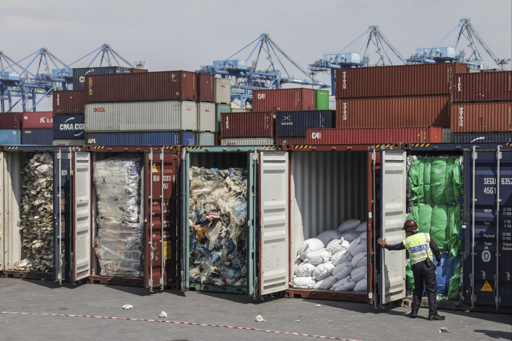 A police officer inspects plastic waste inside cargo containers before it is sent back to the country of origin in Port Klang, Malaysia’s Selangor in 2019. Photo: EPA-EFE