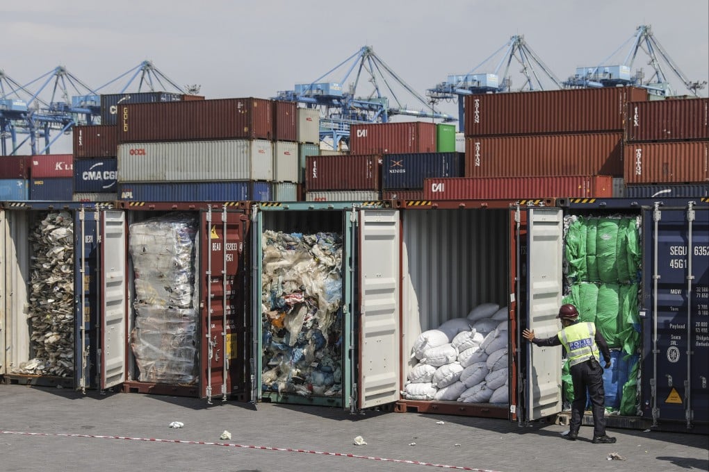 A police officer inspects plastic waste inside cargo containers before it is sent back to the country of origin in Port Klang, Malaysia’s Selangor in 2019. Photo: EPA-EFE