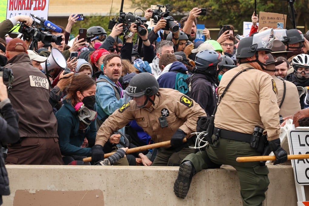 Members of the Illinois state police and Cook County sheriff’s office tussle with protesters near the US Immigration and Customs Enforcement holding facility in Broadview, Illinois, on October 10. Photo: TNS