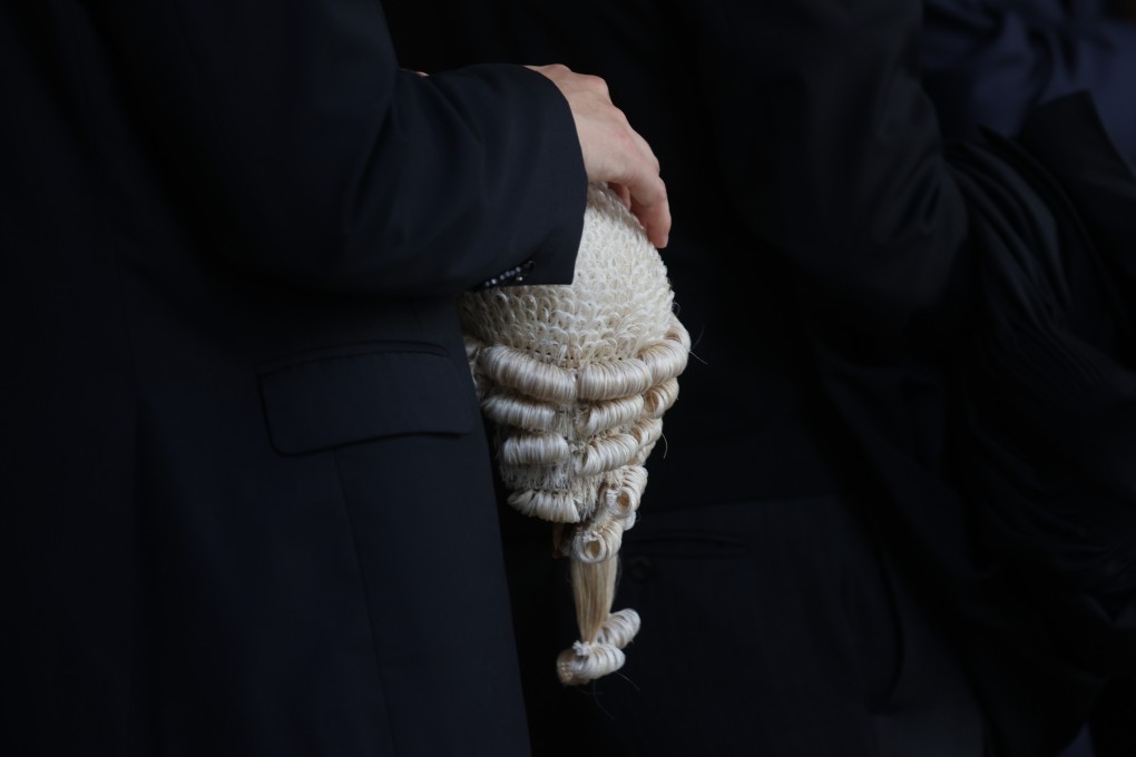 A barrister holds his wig at a senior counsel appointment ceremony, held at the High Court building in Central in May 2024. Photo: Yik Yeung-man.