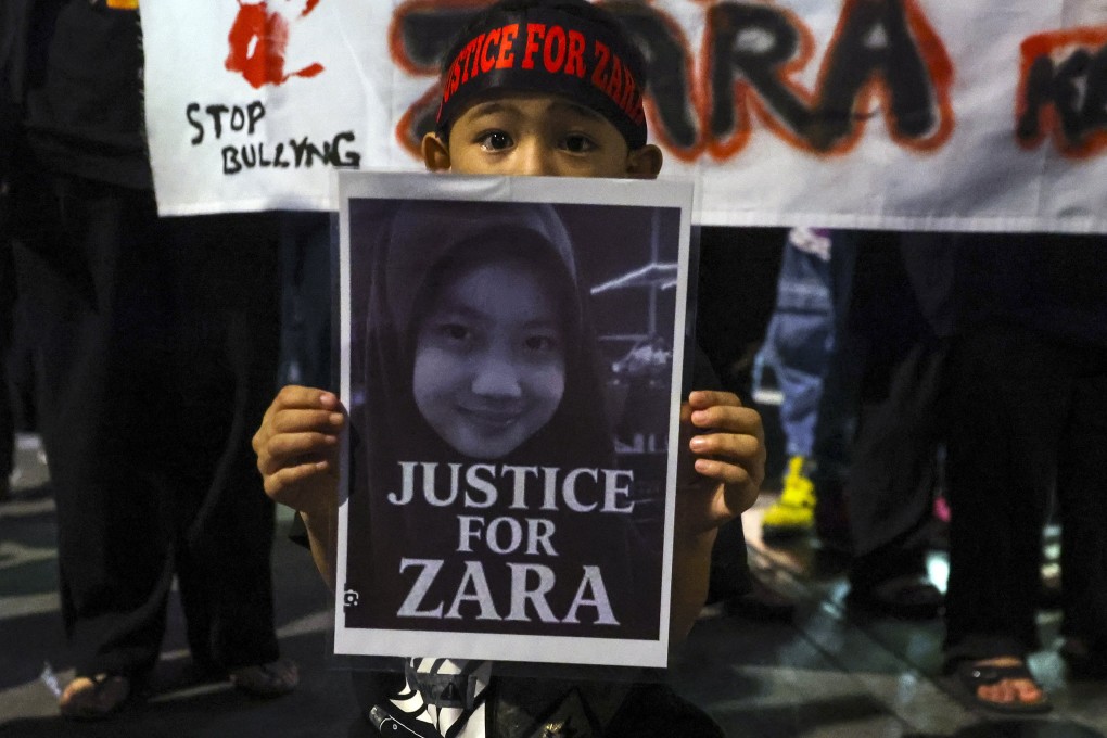A child holds a placard during a rally expressing solidarity with bullying victim Zara Qairina Mahathir in Kuala Lumpur in August. Photo: EPA
