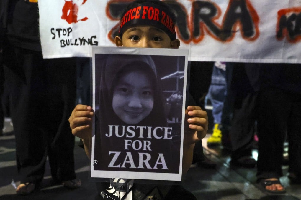A child holds a placard during a rally expressing solidarity with bullying victim Zara Qairina Mahathir in Kuala Lumpur in August. Photo: EPA