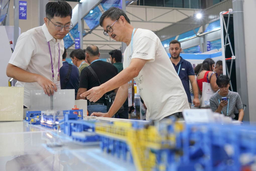 A buyer views a model of an intelligent building materials production line at the Canton Fair in Guangzhou, Guangdong province, last week. Photo: Xinhua