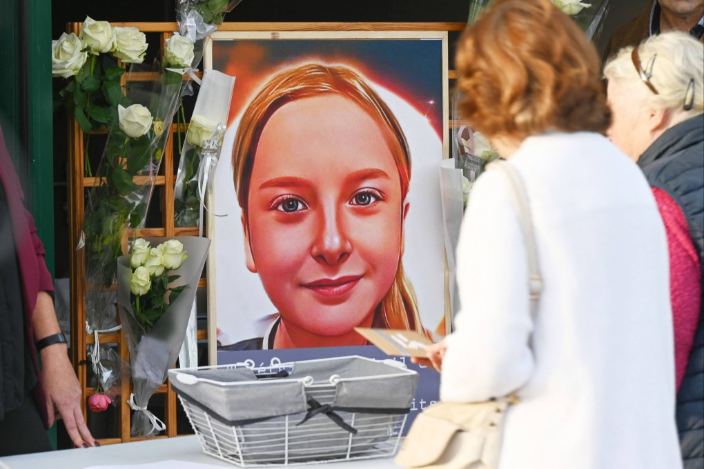 Locals lay notes and flowers near a portrait of Lola Daviet in Fouquereuil, France, in October 2022. Photo: AFP