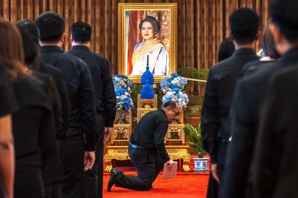 Mourners line up to pay respects in front of a portrait of Thai Queen Sirikit inside the Grand Palace in Bangkok on Sunday. Photo: AFP