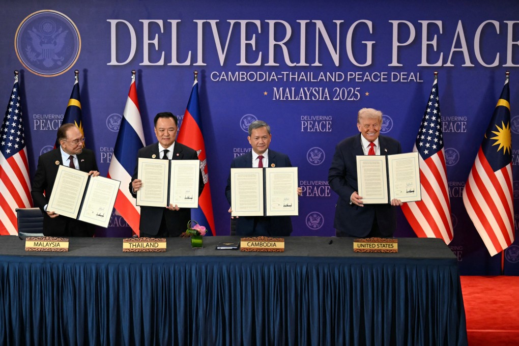 (From left) Malaysian Prime Minister Anwar Ibrahim, Thai leader Anutin Charnvirakul, Cambodia’s Hun Manet and US President Donald Trump hold up documents after the signing of a ceasefire pact between Bangkok and Phnom Penh at the Asean summit in Kuala Lumpur on Sunday. Photo: Reuters