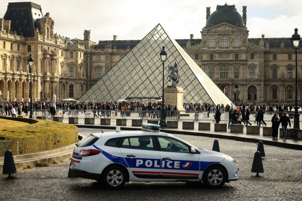 A police car parks in the courtyard of the Louvre museum, one week after the robbery, on Sunday. Photo: AP