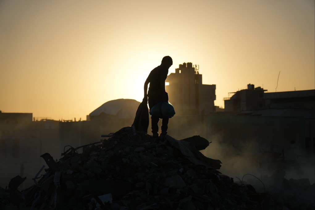 Palestinians search for firewood and plastic at a landfill in Gaza City on Saturday. Photo: AP