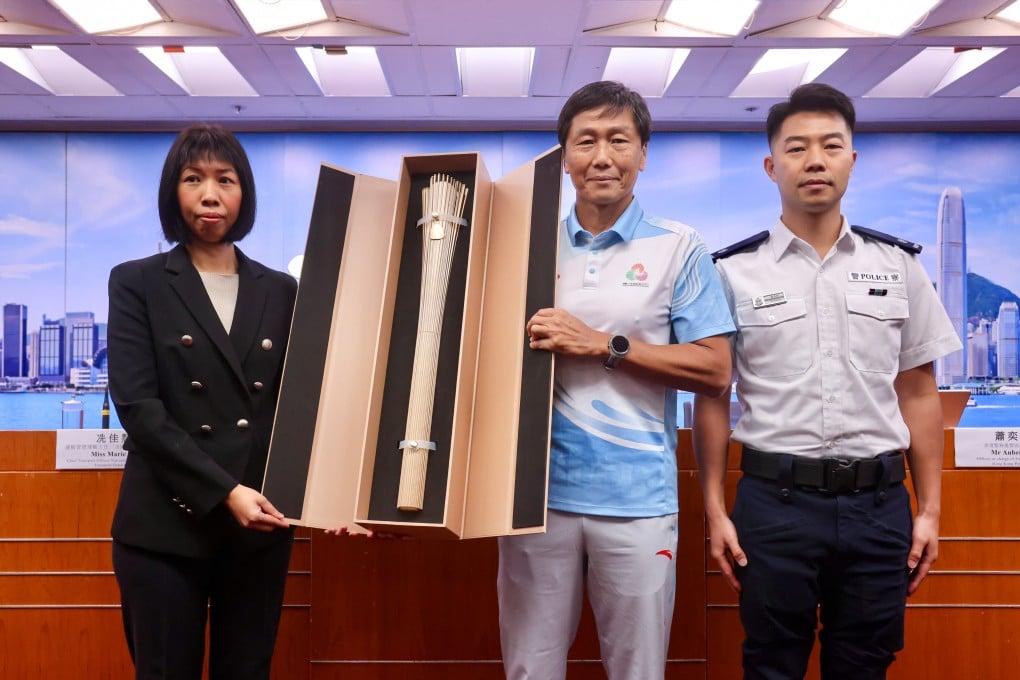 (From left) Marie Sin, Yeung Tak-keung and Superintendent Aubrey Siu with the torch for the relay. Photo: Jonathan Wong