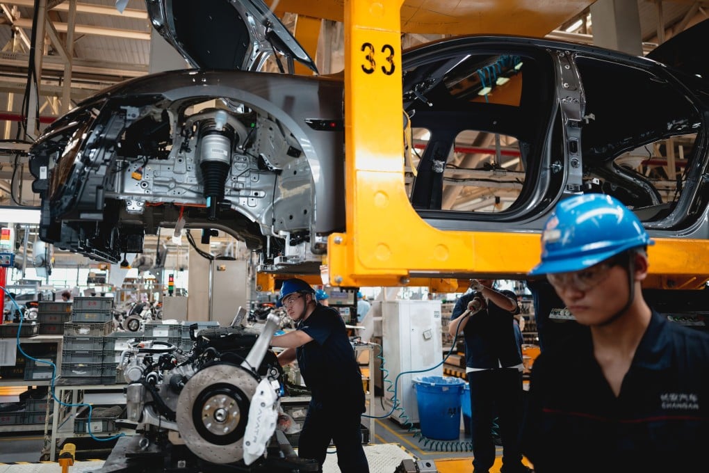 Employees work on an electric vehicle assembly line in Chongqing, on May 20. EPA-EFE