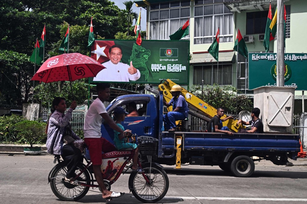 People drive past an election campaign billboard of Myanmar’s chairman of the army-backed ruling Union Solidarity and Development Party Khin Yi ahead of the start of the election campaign in Yangon on Monday. Photo: AFP