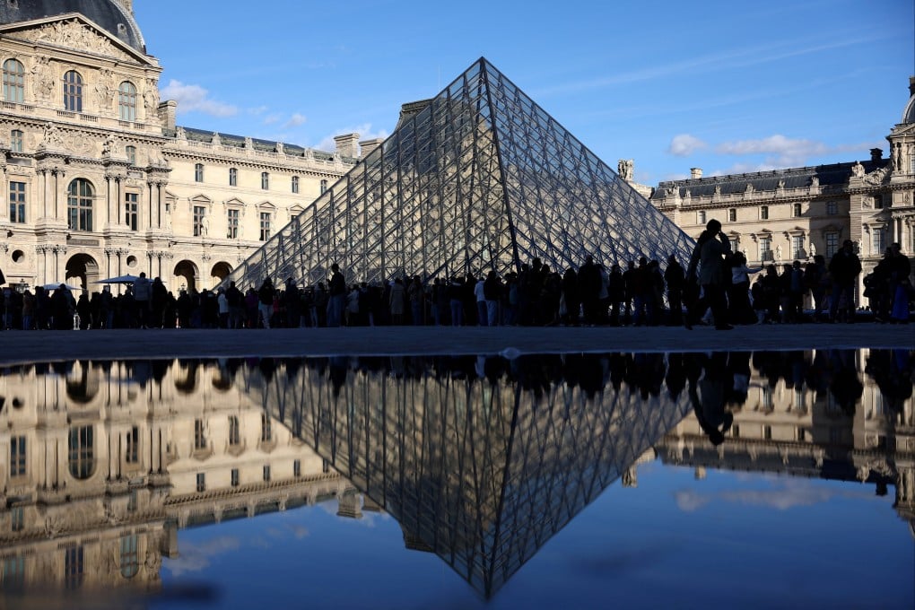 People stand outside the Louvre museum in Paris on Sunday. Photo: Reuters