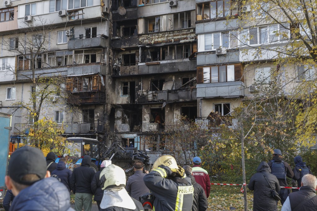 Ukrainian rescuers work at the site of a Russian strike in Kyiv on Sunday. Photo: EPA