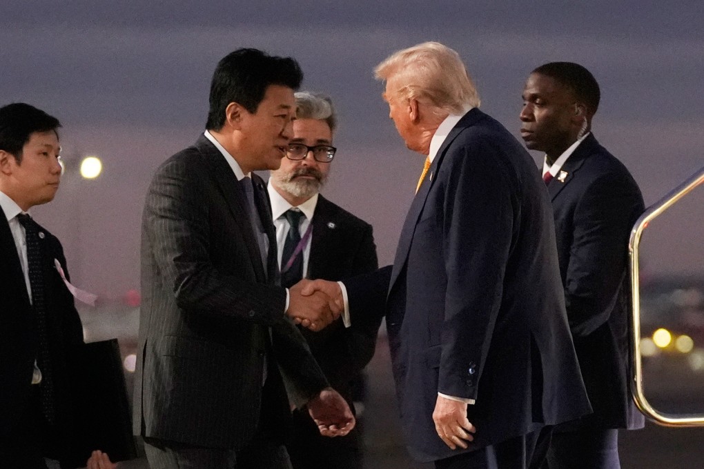 Japan’s Chief Cabinet Secretary Minoru Kihara shakes hands with US President Donald Trump as he arrives at Haneda Airport in Tokyo on Monday. Photo:  AP
