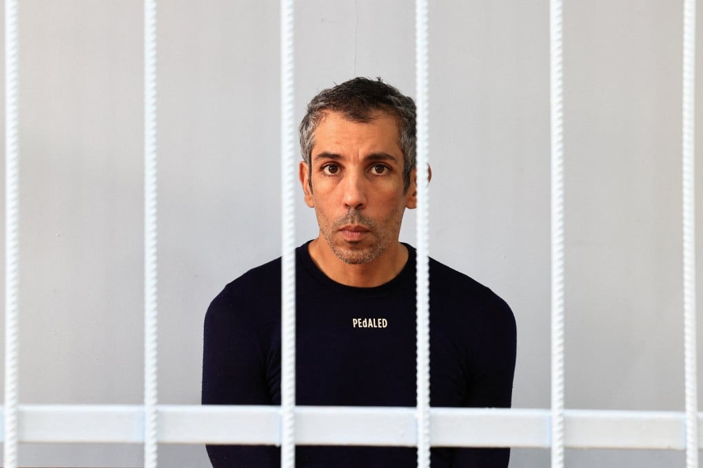 French cyclist Sofiane Sehili inside an enclosure for defendants before a court hearing in the far eastern settlement of Pogranichniy, Russia on Monday. Photo: Reuters