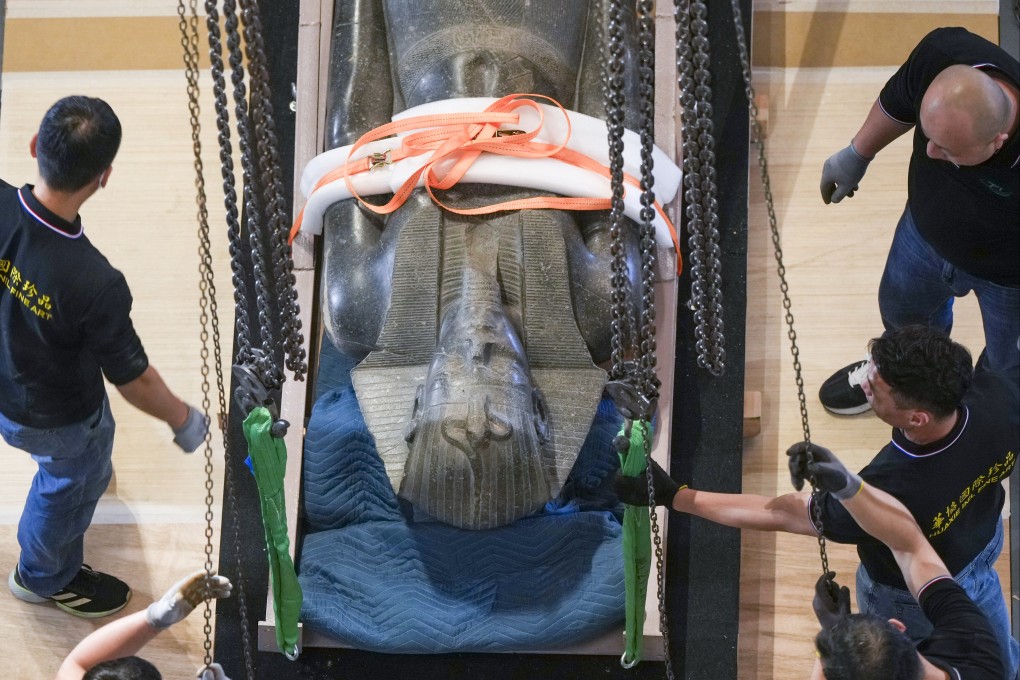 A 2.4-metre (7.9-foot) tall statue of the pharaoh Merenptah is uncrated at the Hong Kong Palace Museum. Photo: Sam Tsang