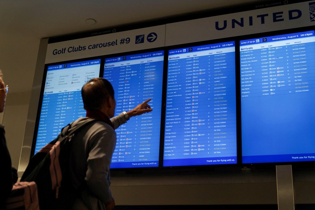 A traveller looks at a flight arrival screen amid flight cancellations at Newark Liberty International Airport in Newark, New Jersey on Monday. Photo: Reuters