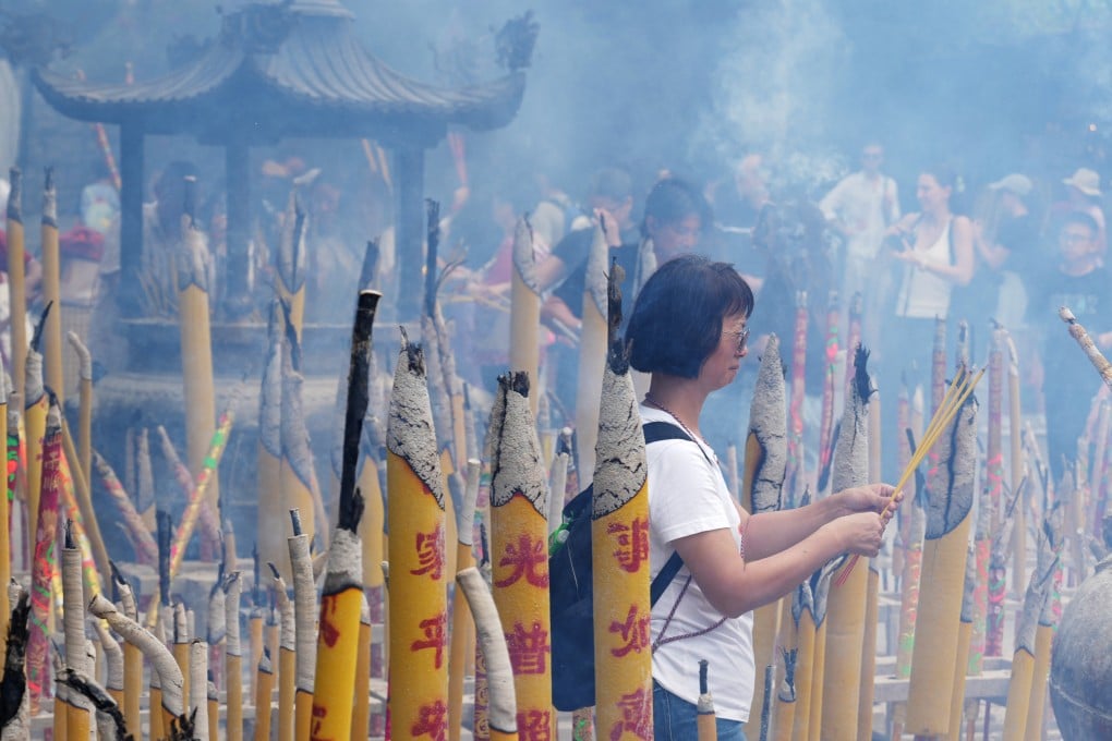 Joss sticks are burned at a Buddha Bathing Ceremony to commemorate the birth of the Buddha at the Po Lin Monastery in Lantau, Hong Kong, on May 5. Photo: May Tse