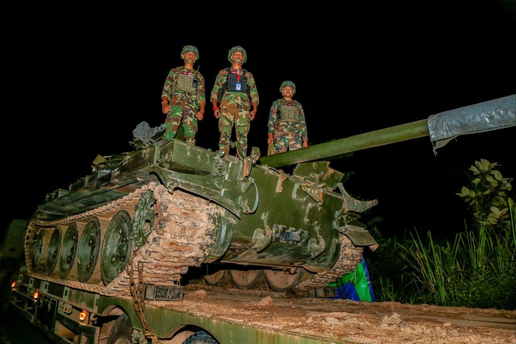 Cambodian soldiers standing atop a tank along a street in Preah Vihear province near the border between Cambodia and Thailand. Photo: AFP/Agence Kampuchea Press
