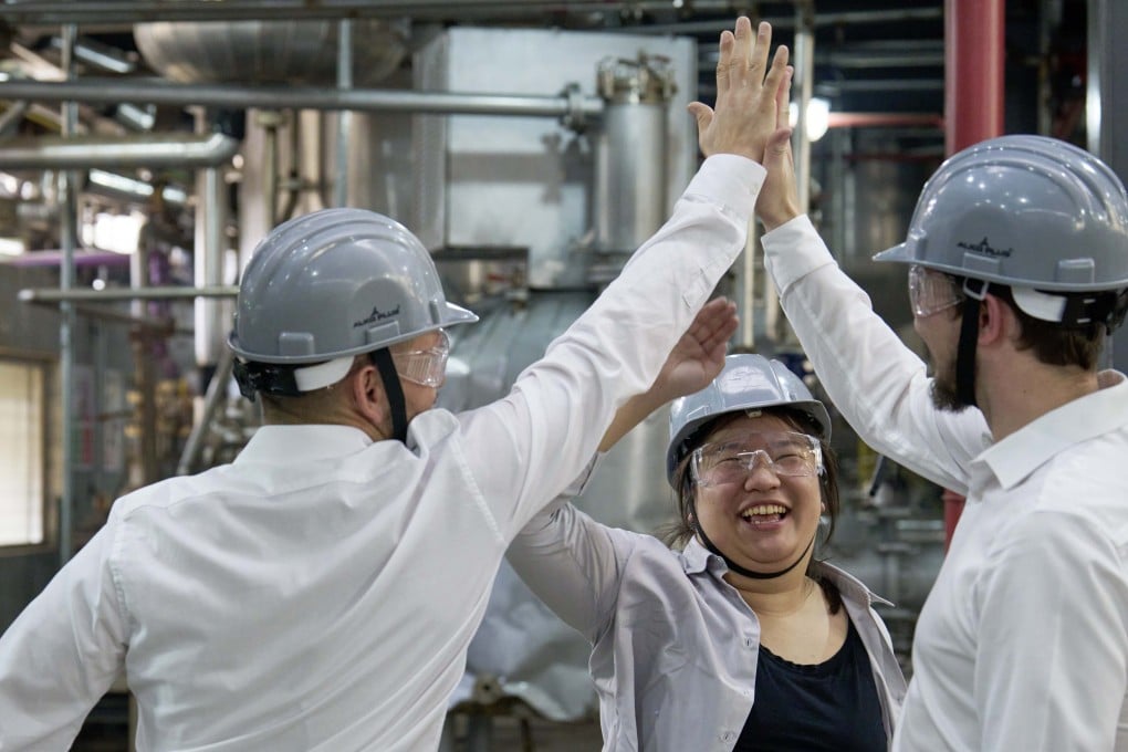 Miranda Wang (centre), co-founder of Novoloop, celebrates a success with members of her team at its demonstration pilot plant in Surat, India, which began continuous operations in April last year. Photo: Rolex/Greg White