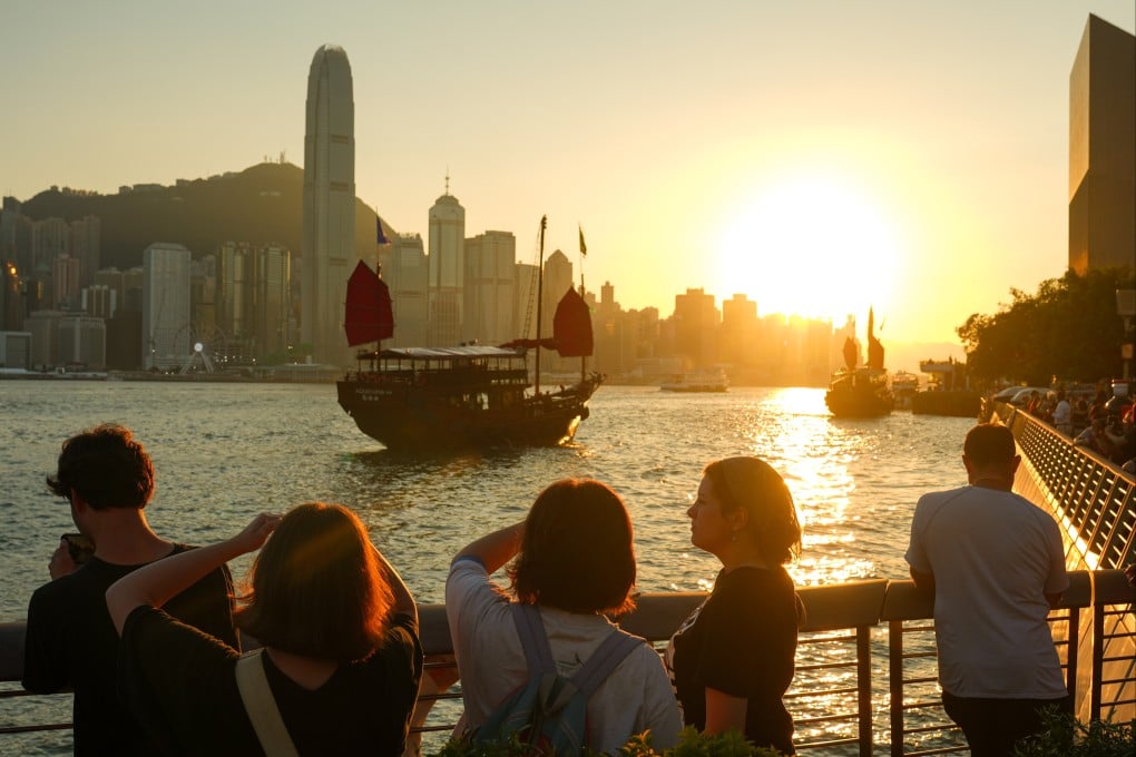 People take in the sunset at the Tsim Sha Tsui waterfront in Hong Kong on October 15. Photo: Sam Tsang