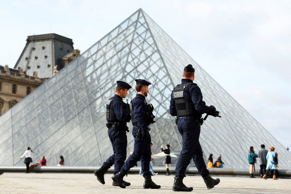 French riot police patrol near the glass Pyramid of the Louvre Museum. Photo: Reuters