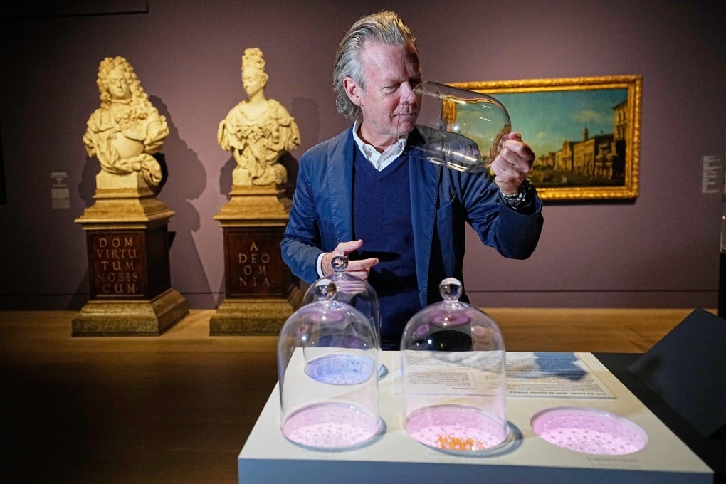 Curator Robert Mueller-Gruenow samples fragrances at the exhibition “The Secret Power of Scents” in Duesseldorf, Germany. Photo: AP