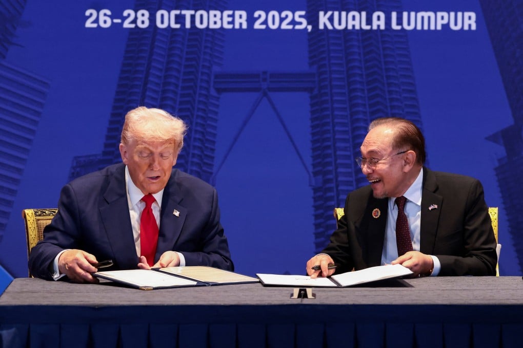 US President Donald Trump and Malaysian Prime Minister Anwar Ibrahim sign trade deal documents during a bilateral meeting at the Asean summit in Kuala Lumpur, Malaysia, on Sunday. Photo: Reuters
