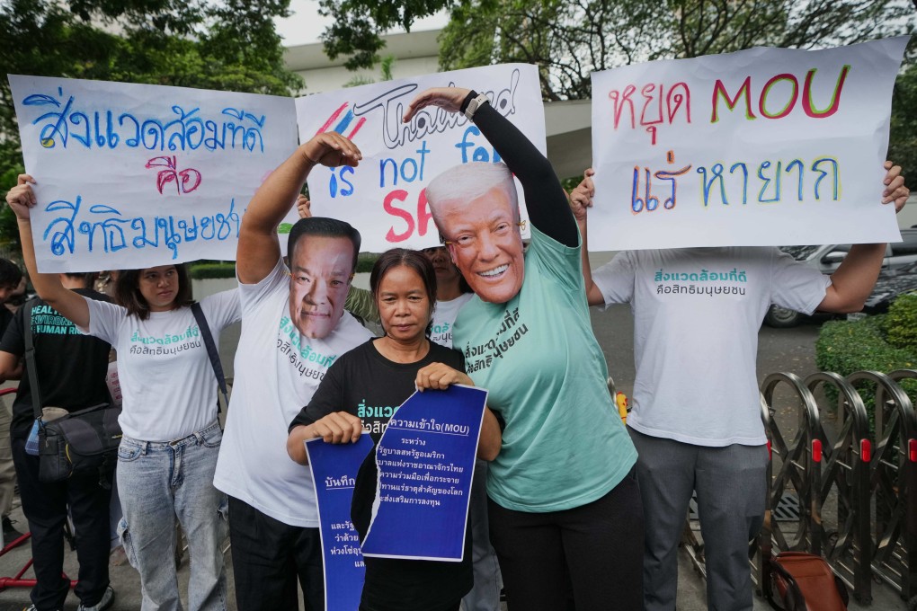Activists wear masks of Thai Prime Minister Anutin Charnvirakul (left) and US President Donald Trump during a protest against an MOU between the two sides outside the US embassy in Bangkok on Thursday. Photo: AP