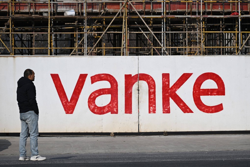 A man stands outside the construction site of a residential complex being built by Chinese real estate developer Vanke in Nanjing, in eastern China’s Jiangsu province, on February 13, 2025. Photo: AFP